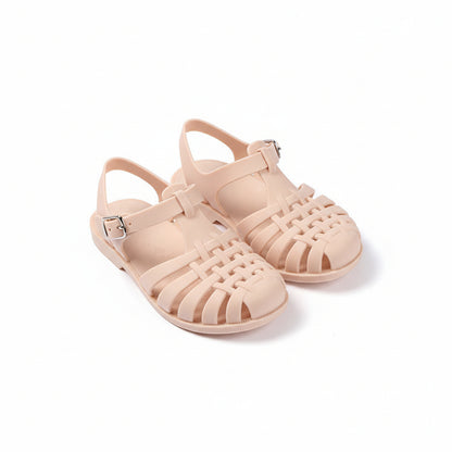 Beige jelly sandals on a white background with text and branding elements.